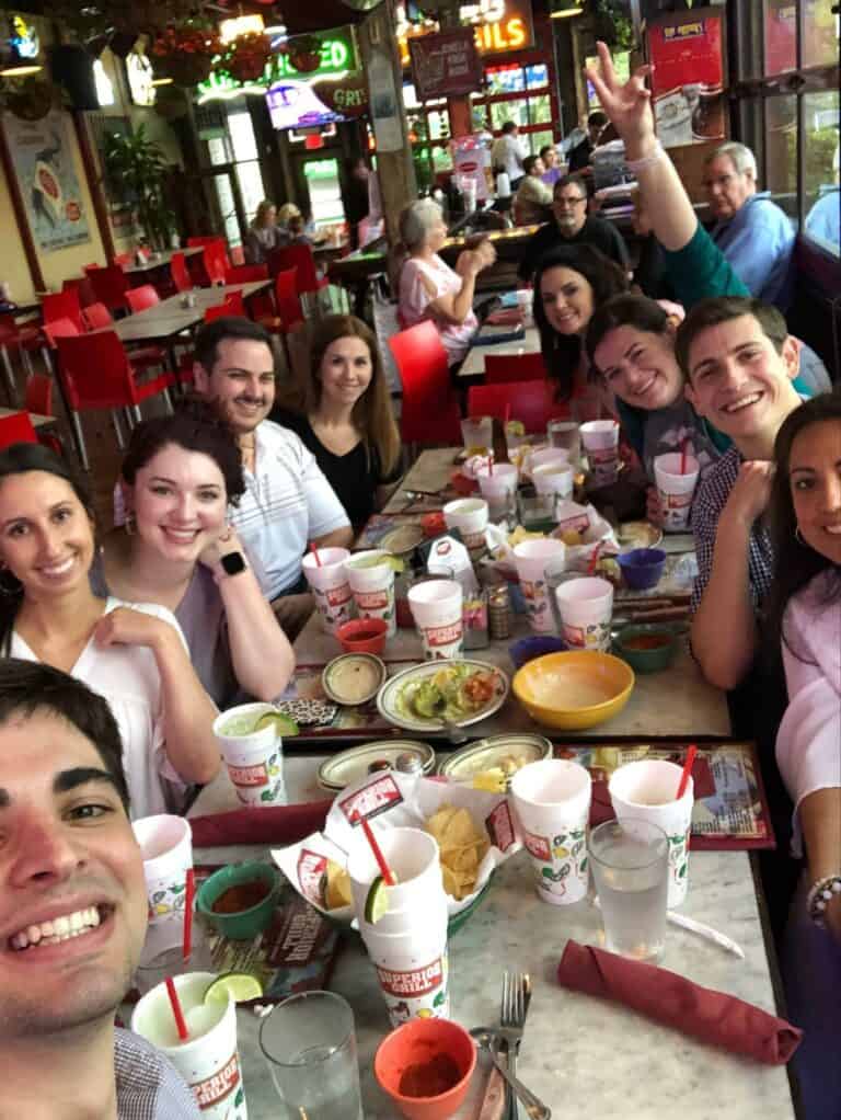 A group of people smiling for a photo at a team lunch